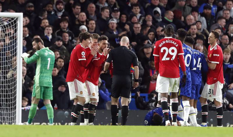 Manchester United players remonstrate with referee Anthony Taylor after a penalty is awarded to Chelsea. Reuters