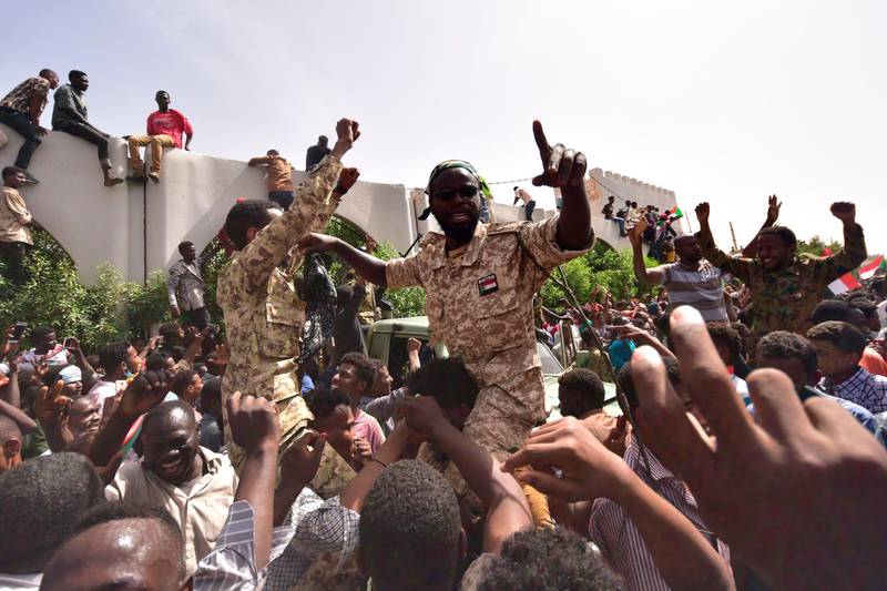 Members of the Sudanese military gather in a street in central Khartoum on April 11, 2019, after one of Africa's longest-serving presidents was toppled by the army. Organisers of protests for the ouster of Sudanese president Omar al-Bashir rejected his toppling by the army Thursday as a "coup conducted by the regime" and vowed to keep up their campaign.
 / AFP / AHMED MUSTAFA
