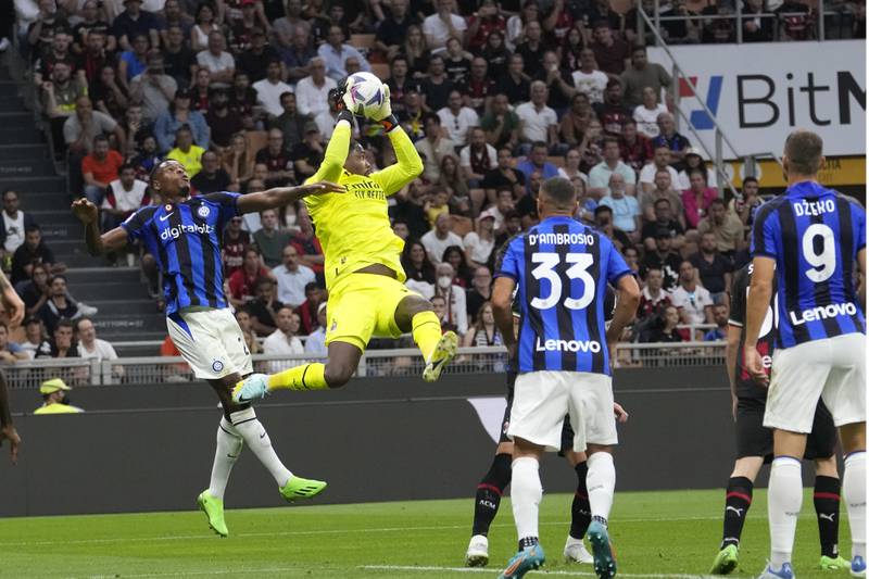 AC Milan goalkeeper Ciprian Tatarusanu catches the ball. AP