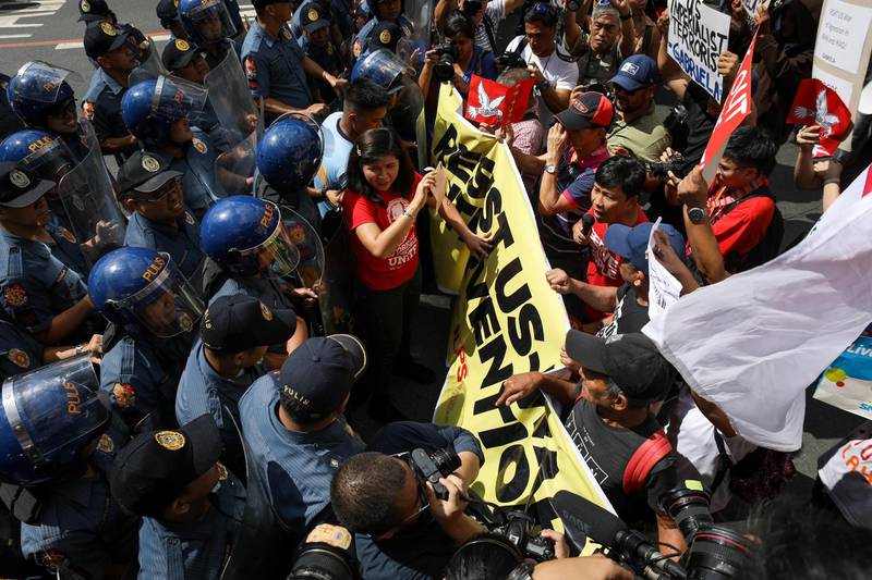 Activists clash with anti-riot police during a demonstration in front of the US Embassy in Manila, Philippines.  EPA