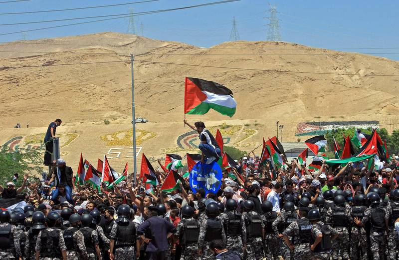 Protesters fly the flag of Palestine as they demonstrate in solidarity with Palestinians, in the town of Karameh, Jordan. AFP