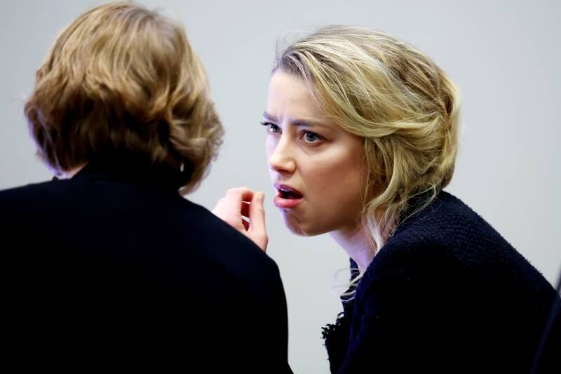 Amber Heard and a member of her legal team. EPA