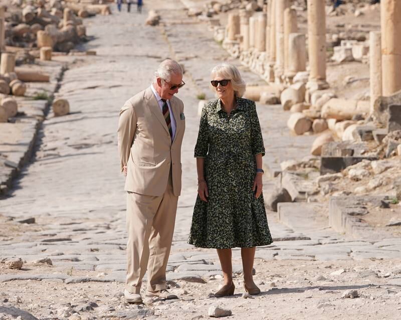 Prince Charles and Camilla, wearing a green floral dress, at the of Umm Qais in Jordan on November 17, 2021. Getty Images