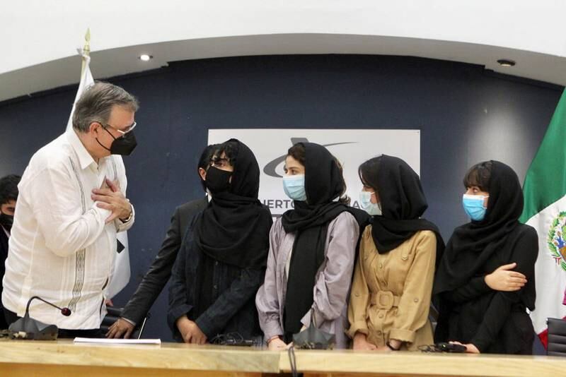 Mexico's Foreign Minister Marcelo Ebrard welcomes members of Afghanistan's robotics team after arriving in Mexico to apply for humanitarian status on August 24, 2021. Reuters
