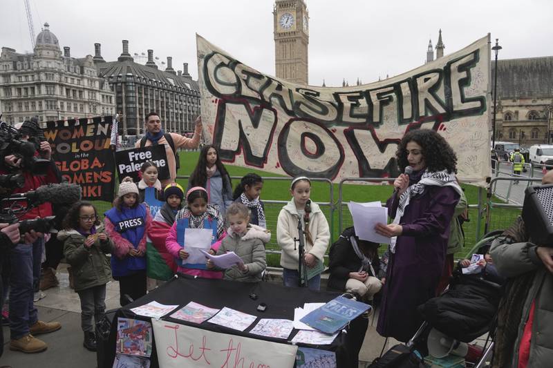 Zeina Saleh, with schoolchildren reading out messages of support of Palestinians in Parliament Square, central London. Photo: AP