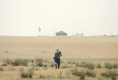 Dubai, United Arab Emirates - March 09, 2020: Weather. A family heads out for an early morning walk in the desert on a foggy morning in Dubai. Monday, March 9th, 2020 in Dubai. Chris Whiteoak / The National