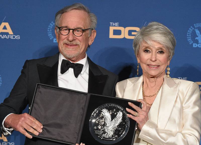 US director Steven Spielberg holds his nominee plaque in the Outstanding Directorial Achievement in Theatrical Feature Film category for "West Side Story" as he poses with Puerto Rican actress Rita Moreno. AFP