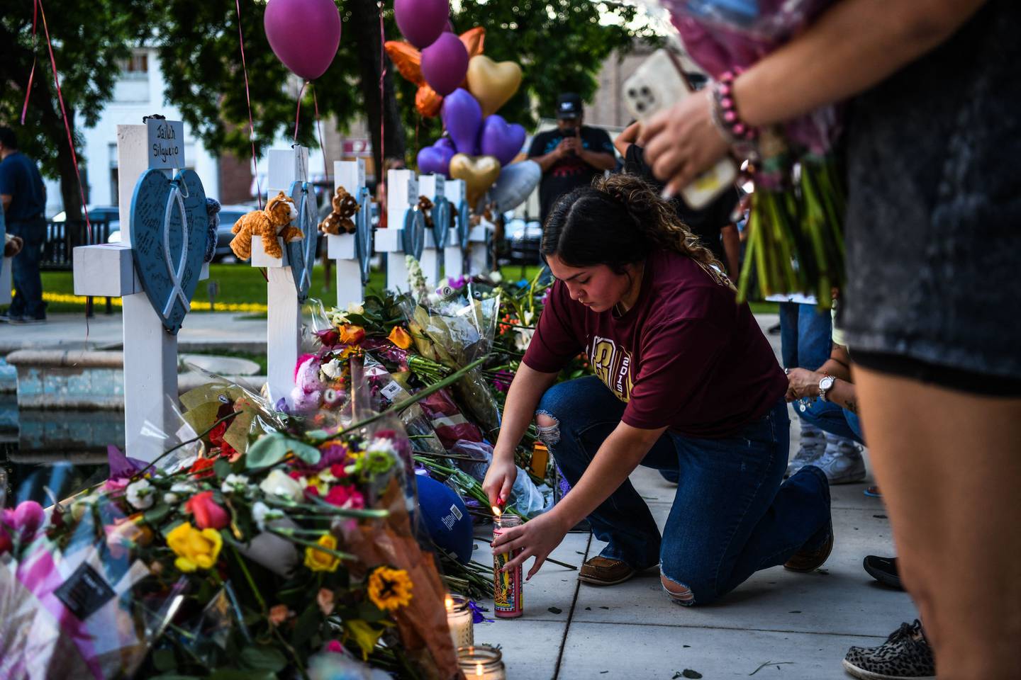 A woman lights a candle at the memorial in Uvalde, Texas. Photo: AFP 