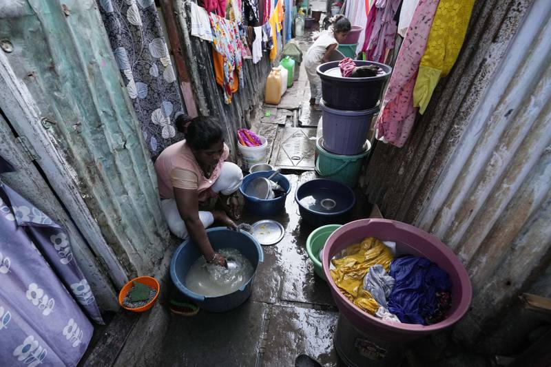A woman washing up outside her house in a slum on the eve of World Water Day in Mumbai, India. AP Photo