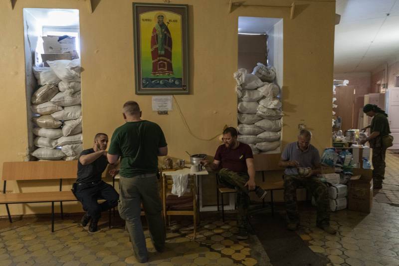 Members of a medical rescue team gather inside their temporary base in the Donetsk region of eastern Ukraine. AP