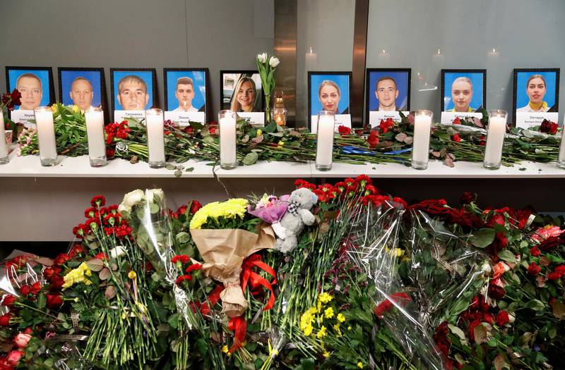 Flowers and candles are placed in front of the portraits of the flight crew members of the Ukraine International Airlines Boeing 737-800 plane that crashed in Iran, at a memorial at the Boryspil International airport outside Kiev.  Reuters