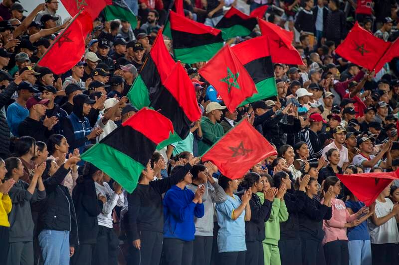 Rabat supporters wave flags in the stadium.