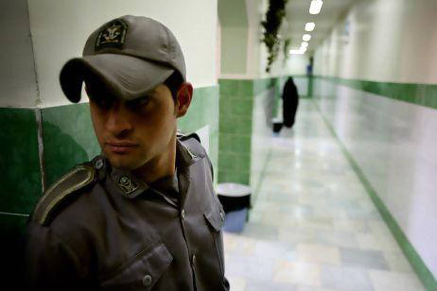 A guard stands along a corridor in Tehran's Evin prison, where detainees are rarely out of site. Reuters