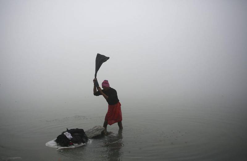 An Indian ‘washerman’ works on the banks of the River Brahmaputra. Anupam Nath / AP Photo