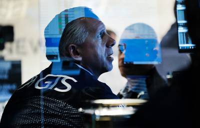 Traders work at the New York Stock Exchange at the start of trading on Monday following Friday's steep decline in global stocks over fears of the new Omicron Covid-19 variant discovered in South Africa. Getty Images / AFP