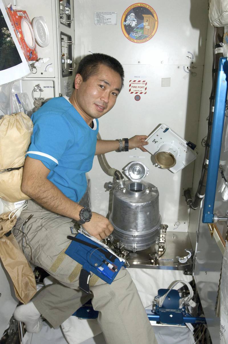 This NASA handout file photo from April 12, 2009 shows Japan Aerospace Exploration Agency (JAXA) astronaut Koichi Wakata as he performs the daily ambient flush of the potable water dispenser in the waste and hygiene compartment located in the Destiny laboratory of the International Space Station. The station's phone booth size bathroom is being repaired after the system's dose pump failed after running for about 15 minutes on July 19, 2009.        REUTERS/NASA TV (SCI TECH) FOR EDITORIAL USE ONLY. NOT FOR SALE FOR MARKETING OR ADVERTISING CAMPAIGNS
