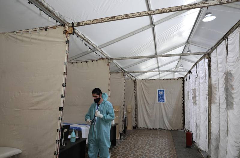 A staff member prepares to join his colleagues inside a Covid-19 triage tent at Al Bashir hospital in Amman. EPA
