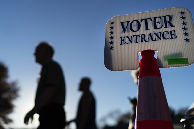 Voters pass by a sign outside a polling site in Warwick, Rhode Island after casting their ballots on the last day of early voting before the midterm election. AP 
