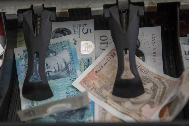 A cash register holds British pound banknotes at a fruit and vegetable stall at Watney Market in London, U.K., on Thursday, Nov. 28, 2019. The pound headed for a fourth month of gains against the euro, reflecting growing confidence in the market that the Conservative Party will be able to secure a majority in the U.K.'s December election. Photographer: Simon Dawson/Bloomberg