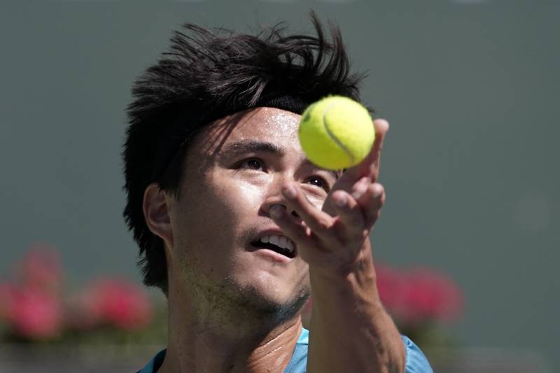 Taro Daniel, of Japan, serves to Andy Murray, of Britain. AP Photo