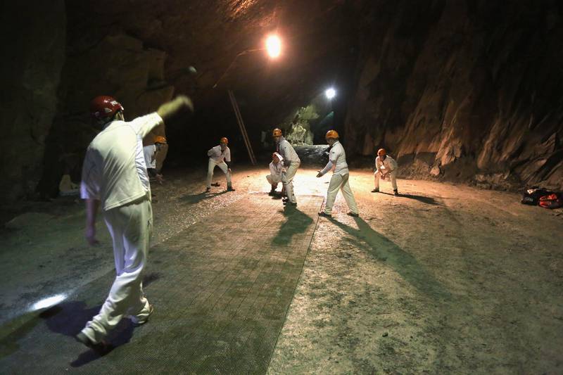 KESWICK, ENGLAND - DECEMBER 05:  Cricketers from village teams Threlkeld and Caldbeck take part in the world's first underground cricket match inside Honister Slate Mine on December 5, 2013 in Keswick, England. The Christmas fixture took part 600m (2,000ft) inside Fleetwith Pike at  Englands last working slate mine at Honister in the Lake District. The game is one of many unusual venues the teams have played in to raise money to fix Threlkeld Cricket Club's flood damaged ground. The match was won by Caldbeck Village.  (Photo by Christopher Furlong/Getty Images)