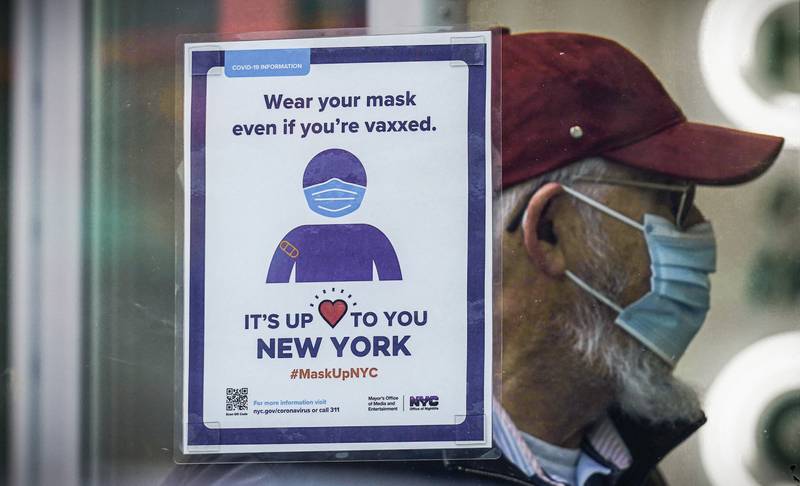 A sign reminds customers that masks are required in a store in New York. AP