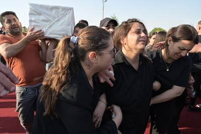 Iraqi Christians mourn next to a coffin for a victim of wedding hall fire, during a mass funeral in Hamdaniya town, northern Iraq. EPA