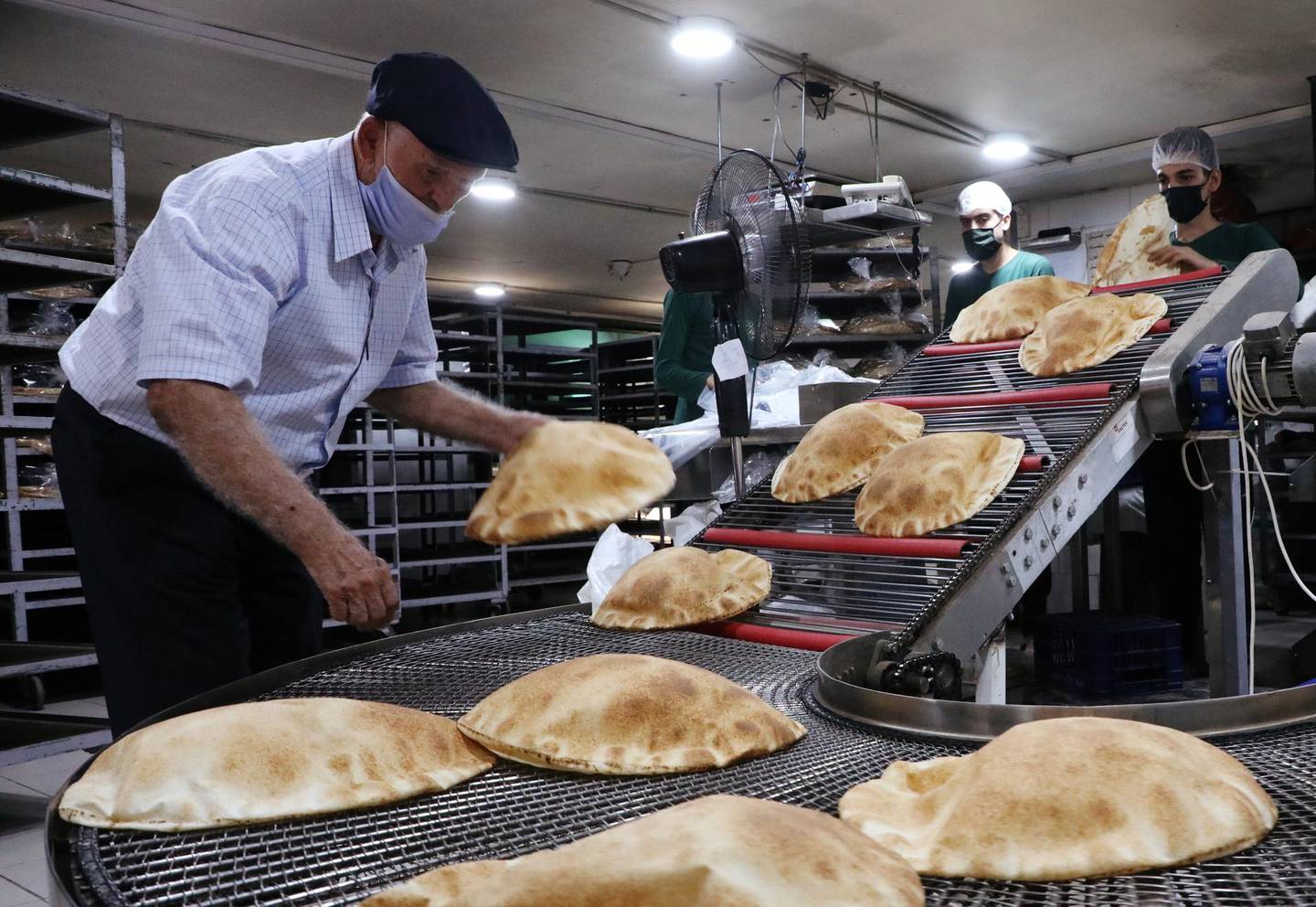 Workers wearing protective masks prepare baked breads inside a bakery in Beirut, Lebanon October 8, 2020. Picture taken October 8, 2020. REUTERS/Mohamed Azakir