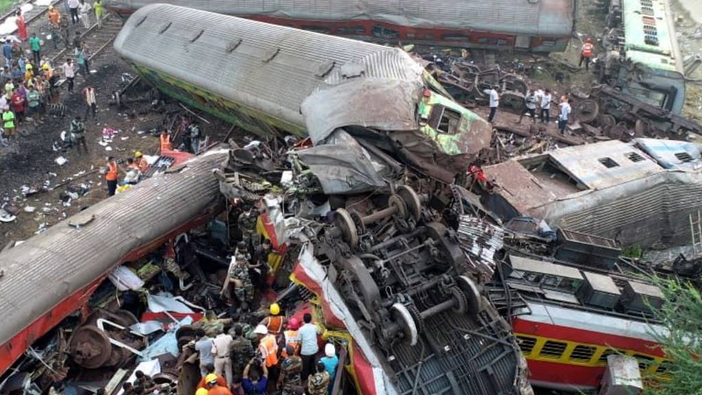 India train crash: Rescuers cut through mangled carriages