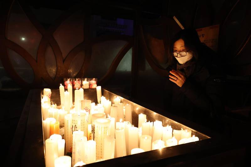 A woman prays at the Chogey temple during the New Year's Eve in Seoul, South Korea. Getty Images