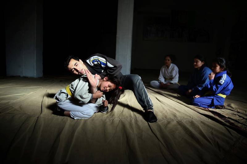 Jiu Jitsu coach Sayed Jawad Hussaini demonstrates technique during a training session in Kabul. AP