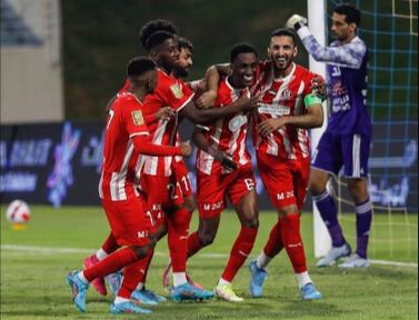 Al Jazira forward Ali Mabkhout, right, celebrates with teammates after scoring a penalty against Al Dhafra to break the UAE league goals record. Photo: PLC