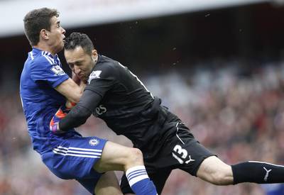 Arsenal keeper David Ospina collides with Chelsea's Oscar during their Premier League contest on Sunday at the Emirates Stadium. Adrian Dennis / AFP