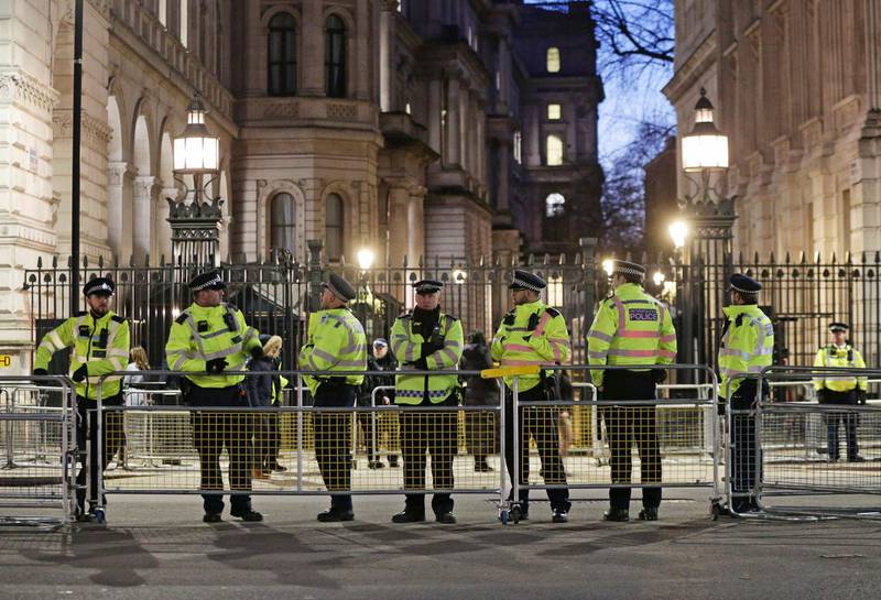 British police officers secure the area outside Downing Street in London, as protesters demonstrate against the visit by Saudi Arabia's Crown Prince Mohammed bin Salman, Wednesday March 7, 2018.  Saudi Arabia's Crown Prince Mohammed bin Salman received a royal welcome with high level political talks to begin his three day visit to Britain, although protesters criticised the visit. (Yui Mok/PA via AP)