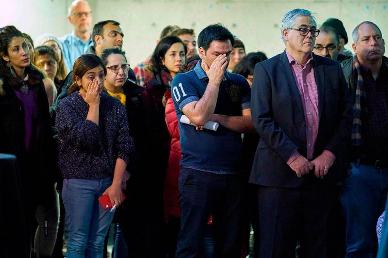Attendees wipe away tears during a memorial service at Western University in London, Ontario on January 8, 2020 for the four graduate students who were killed in a plane crash in Iran. AFP