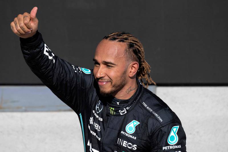 Mercedes' British driver Lewis Hamilton celebrates on the podium after finishing third at the Canada Formula 1 Grand Prix. AFP