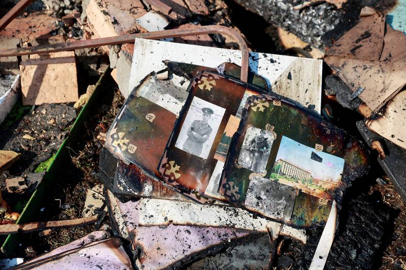 Pictures lie amid the rubble of former teacher Natalia's house in Kyiv, which was hit in a military strike, amid Russia's invasion of Ukraine. Reuters