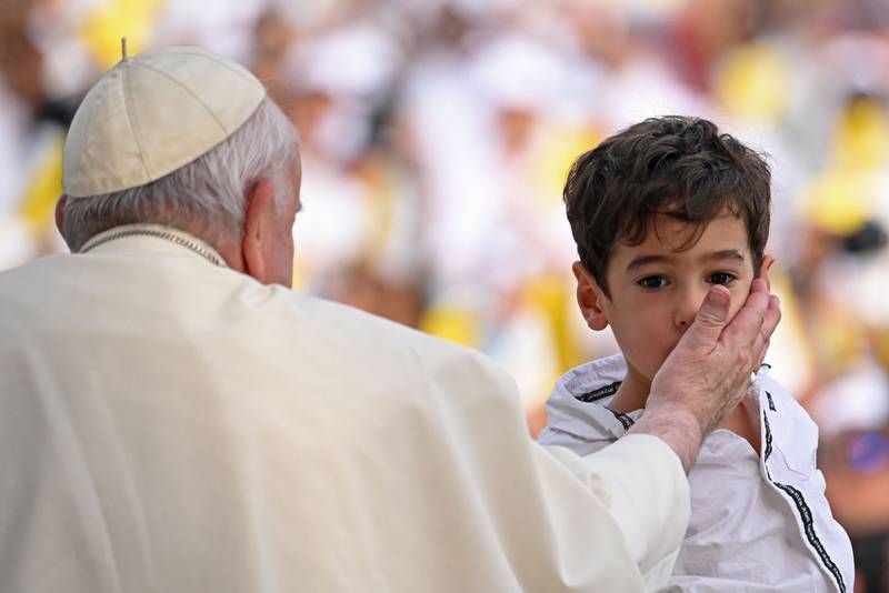 Pope Francis blesses Mark Metry, 4, the grandson of Hala Fayez, a Bahraini parliamentarian, who was at the Bahrain National Stadium to attend the Mass on Saturday. Photo: AFP