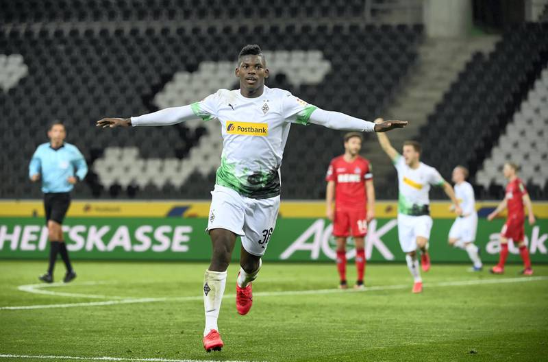 Moenchengladbach's Swiss forward Breel Embolo celebrates scoring the opening goal during the German first division Bundesliga football match Borussia Moenchengladbach v 1 FC Cologne in Moenchengladbach, western Germany on March 11, 2020. - Rhine Bundesliga derby between Borussia Moenchengladbach and Cologne, will be held behind closed doors due to the coronavirus, the first game in Bundesliga history to be played without fans. (Photo by Ina FASSBENDER / AFP) / DFL REGULATIONS PROHIBIT ANY USE OF PHOTOGRAPHS AS IMAGE SEQUENCES AND/OR QUASI-VIDEO