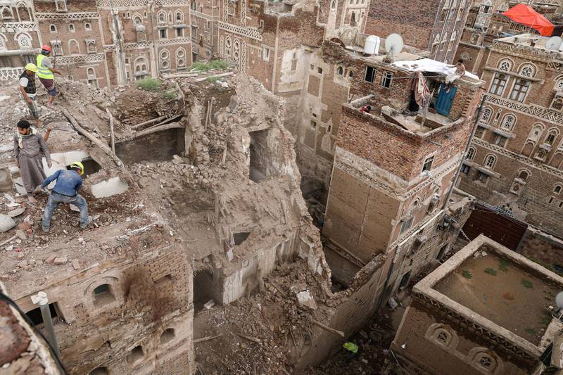 Workers demolish a building damaged by rain in the old city of Sanaa, Yemen August 9, 2020. Reuters
