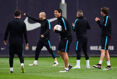 Luis Suarez jokes with Lionel Messi. David Ramos / Getty Images