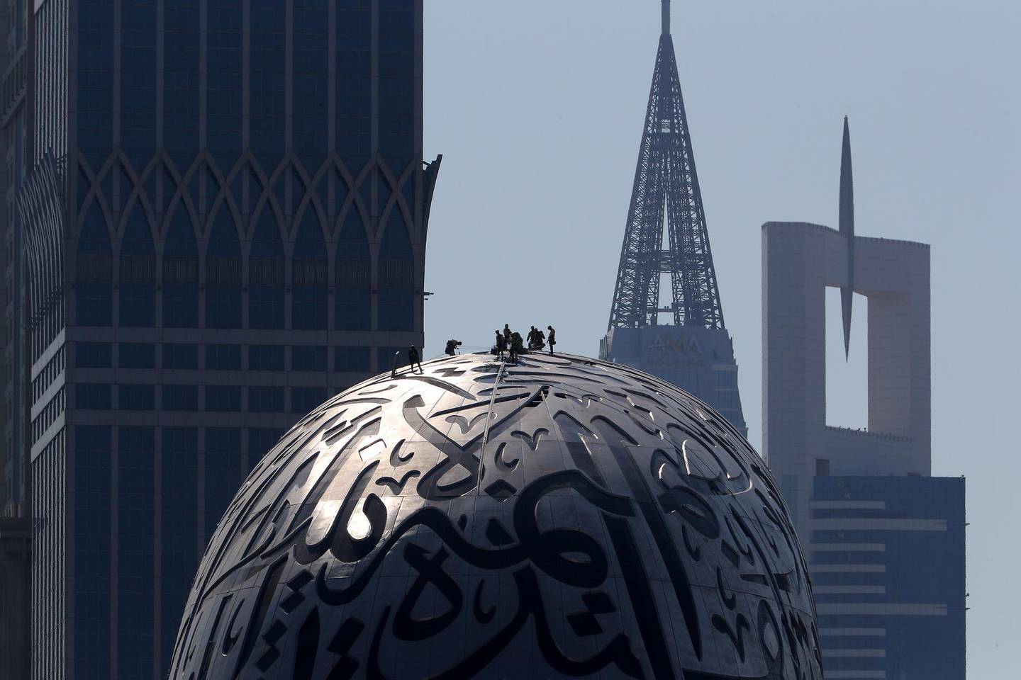 DUBAI, UNITED ARAB EMIRATES, December 9 – Workers working on the Museum of The Future on Sheikh Zayed road in Dubai. (Pawan Singh / The National) For Standalone/Online/Instagram/Big Picture