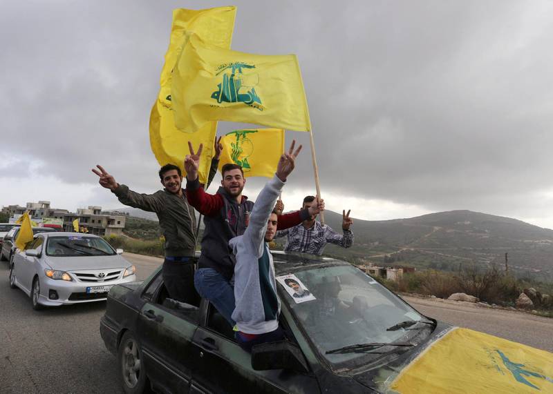 FILE PHOTO: Supporters of Lebanon's Hezbollah leader Sayyed Hassan Nasrallah gesture as they hold Hezbollah flags in Marjayoun, Lebanon May 7, 2018. REUTERS/Aziz Taher/File Photo