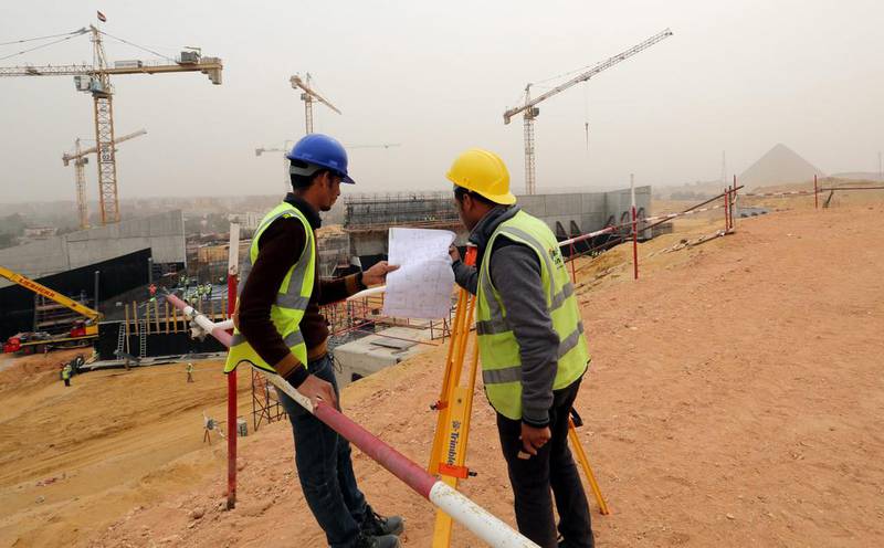 Egyptians workers review a blueprint next to the construction site of the Grand Egyptian Museum, Giza. Khaled Elifiqi / EPA