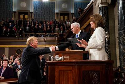 Donald Trump shakes hands with Vice President Mike Pence, as House Speaker Nancy Pelosi  looks on, as he arrives in the House chamber. AP