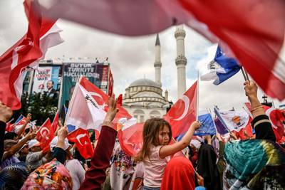 People attend a speech of Turkish President Recep Tayyip Erdogan one day before the elections in Istanbul, Turkey, on June 23, 2018. Aris Messinis / AFP