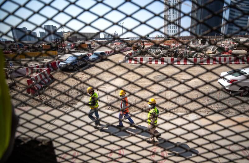 Workers at the Uptown Tower site, close to Dubai’s JLT district.