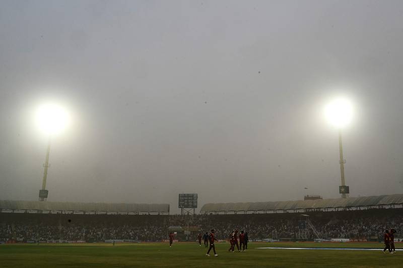 Players walk back to the pavilion after a dust storm disrupted the third ODI between Pakistan and West Indies at the Multan International Cricket Stadium on Sunday, June 12, 2022. AFP