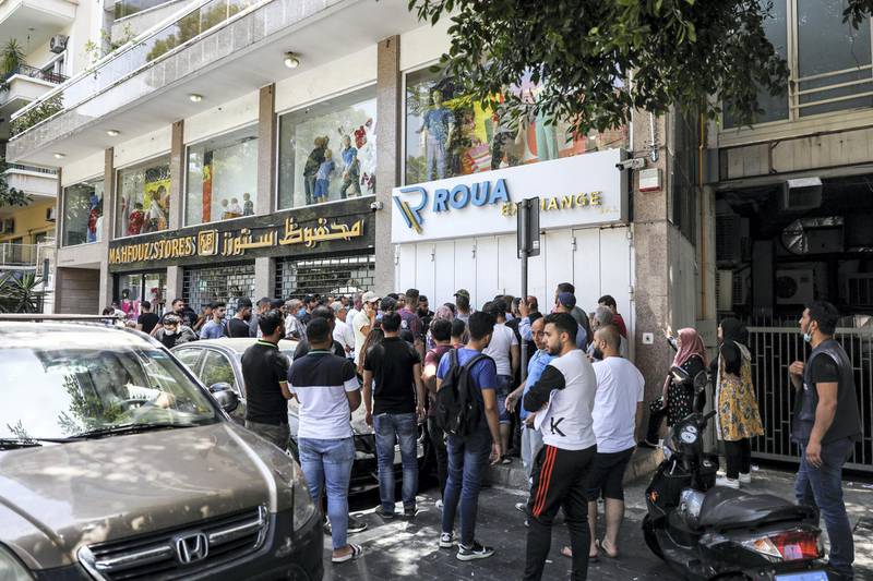 People queue outside a currency exchange bureau in Lebanon's capital Beirut on June 18, 2020. (Photo by JOSEPH EID / AFP)