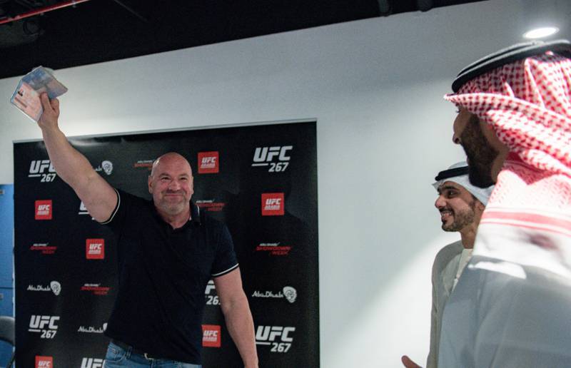 Dana White waves his passport in the air after receiving his golden visa.